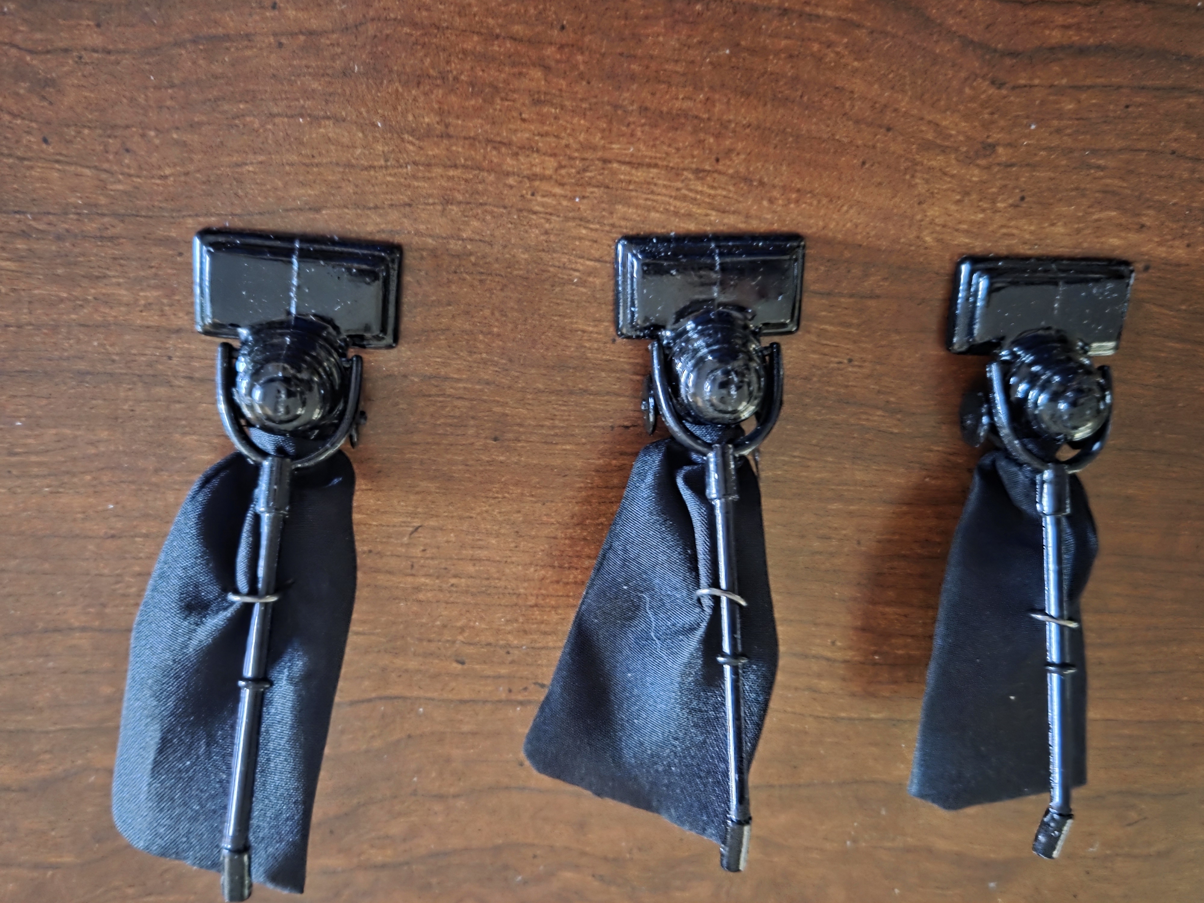 Three miniature Hoover sweepers